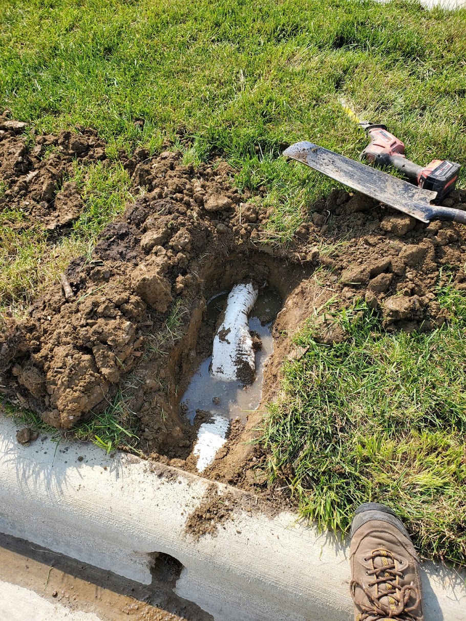 car up over curb crushed pipe